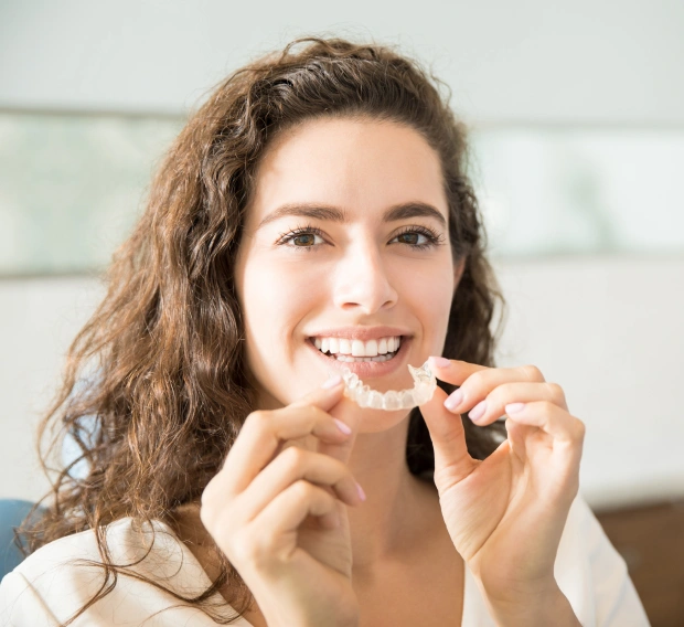 Adult patient smiling while wearing Invisalign clear aligners
